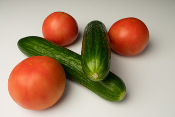 Vegetable shot on a white background: Cucumbers, tomatoes