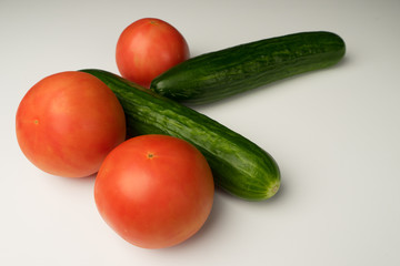 Vegetable shot on a white background: Cucumbers, tomatoes