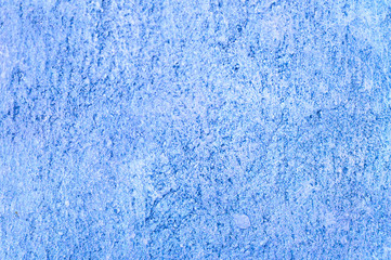 Fototapeta na wymiar Rough texture of abstract decorative dark blue background of plaster wall.