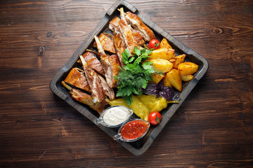 Barbecue on the bones with vegetables and potatoes . catering menu