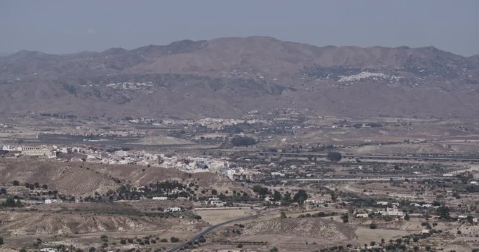 Establishing long shot of a valley near the town of Mojacar in Andalusia, Spain by summer.