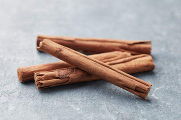 Cinnamon sticks. Christmas spices on rustic wooden background. Close up. 