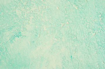 Rough texture of abstract decorative light green background of plaster wall.