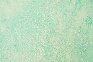 Rough texture of abstract decorative light green background of plaster wall.