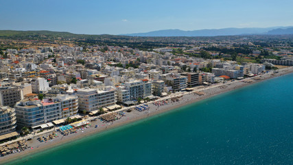 Fototapeta premium Aerial drone photo of famous seaside area and main town of Loutraki with sandy organised beach with turquoise clear sea and resorts, Greece