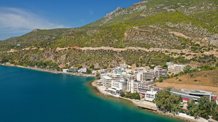 Fototapeta na wymiar Aerial drone photo of famous seaside area and main town of Loutraki with sandy organised beach with turquoise clear sea and resorts, Greece