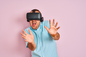 Young plus size man playing virtual reality game using goggles