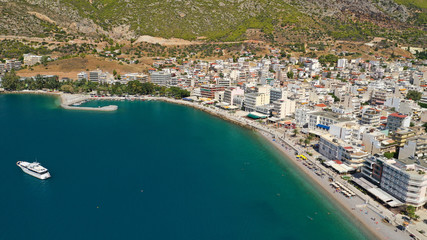 Aerial drone photo of famous seaside area and main town of Loutraki with sandy organised beach with turquoise clear sea and resorts, Greece