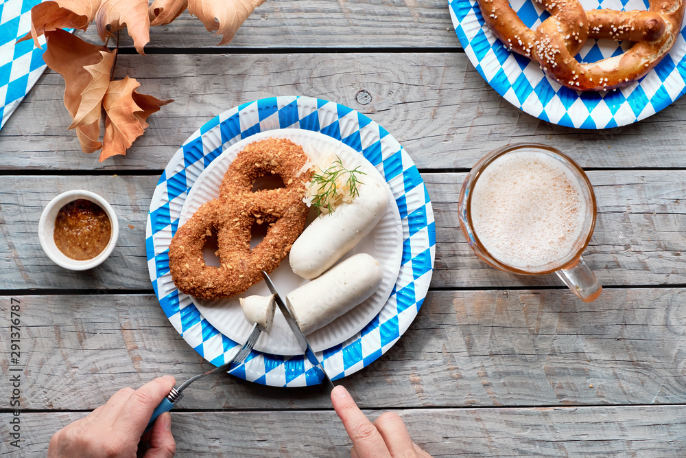 Wall mural Oktoberfest traditional food and beer, flat lay on wooden table