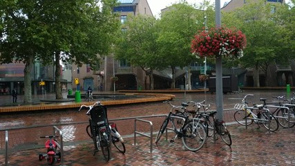 Amsterdam, Holland, August 2019. Urban outskirts of the city near the metro station Amsterdam Bijlmer Arena. Rainy day. Modern architecture. 30fps.