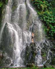 Man in front of a waterfall on the azores islands