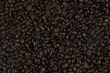 brown roasted coffee beans and coffee cup