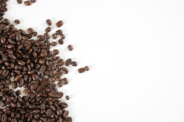 brown roasted coffee beans and coffee cup