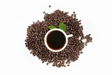 brown roasted coffee beans and coffee cup