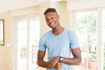 Fototapeta premium Handsome african young man smiling cheerful with a big smile on face