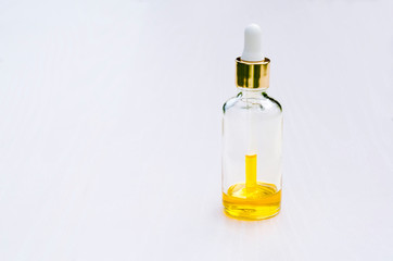 cosmetic product in a glass bottle with a pipette and a drop, serum, essential oil, a medicine for youth and elasticity of the skin. aromatherapy. isolated