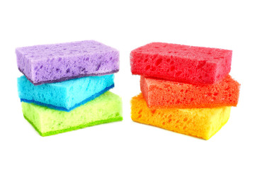Bright colored sponges for cleaning the bathroom, washing dishes and other household needs are located on top of each other in 3 pieces. Isolated.