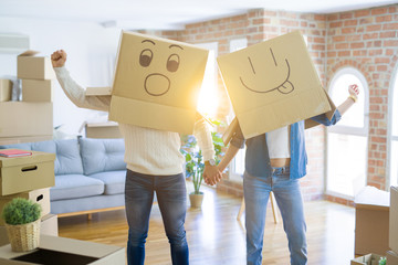 Funny couple wearing cardboard boxes with fun crazy emoji faces over head