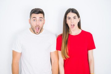 Young beautiful couple together over white isolated background afraid and shocked with surprise expression, fear and excited face.