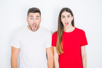 Fototapeta premium Young beautiful couple together over white isolated background afraid and shocked with surprise expression, fear and excited face.