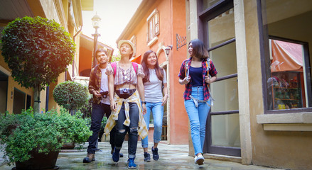 Fototapeta na wymiar Asian Group of young people with friends backpacks walking together and happy friends are taking photo and selfie ,Relax time on holiday concept travel
