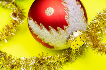 Tinsel Garland and Vintage Christmas Tree Ball isolated on bright yellow background. Winter Holidays Decoration concept.