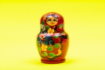 Colorful Nesting wooden Dolls isolated on bright yellow background. National Russian souvenirs. Babushkas or Matryoshkas.