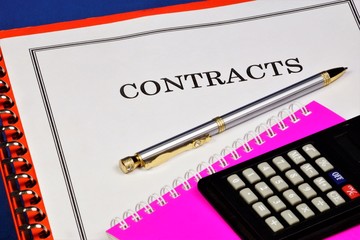 Contracts are a prospect of financial profit, a successful strategy of the office. On the expert's Desk, pen, folder, calculator, document form for signature, the result of market analysis.