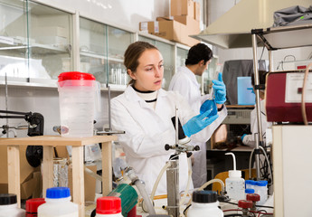 Female student examining chemical substances