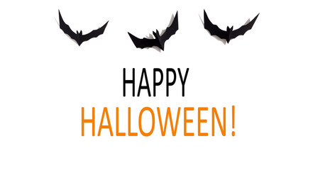 Happy Halloween message with paper bats overhead view on a solid color