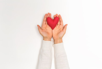 Young woman holding a big Valentine's day heart on a white background