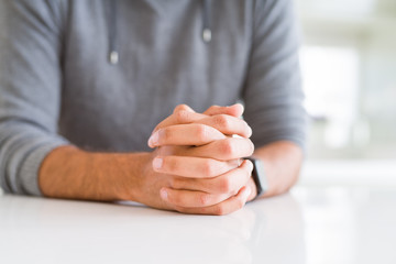 Naklejka premium Close up of man with crossed hands over white table