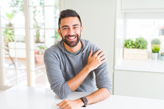 Handsome man smiling cheerful with a big smile on face showing teeth, positive and happy expression