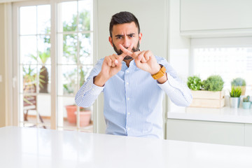 Handsome hispanic business man Rejection expression crossing fingers doing negative sign