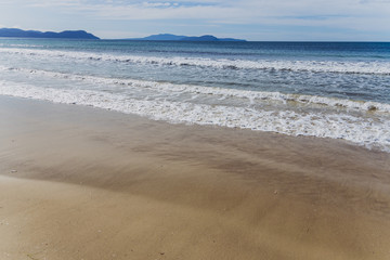 sunny pristine and deserted beach overlooking the South Pacific Ocean