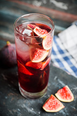 Cocktail with figs on the rustic background. Selective focus. Shallow depth of field.