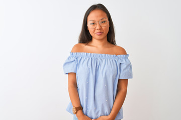 Young chinese woman wearing blue t-shirt and glasses over isolated white background depressed and worry for distress, crying angry and afraid. Sad expression.