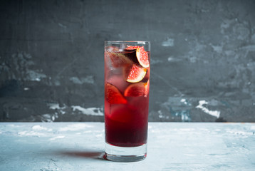 Cocktail with figs on the rustic background. Selective focus. Shallow depth of field.