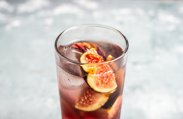 Cocktail with figs on the rustic background. Selective focus. Shallow depth of field.