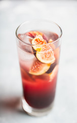 Cocktail with figs on the rustic background. Selective focus. Shallow depth of field.