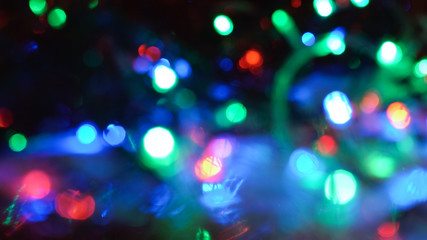 Christmas colorful New Year's Bokeh neon lights. Abstract Blurred photo background with blinking...
