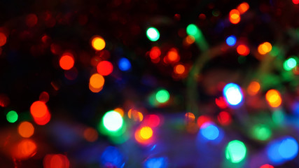 Christmas colorful New Year's Bokeh neon lights. Abstract Blurred photo background with blinking...