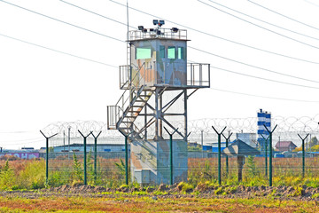 Guard tower and fence around a military unit. Russia. Siberia