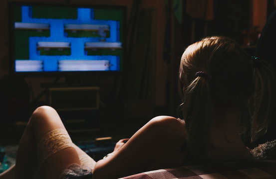 Anime girl playing console sitting on the floor