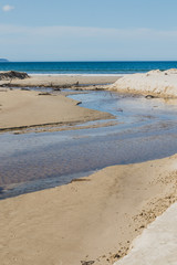 river estuary across the beach meeting the South Pacific Ocean in Marion Bay