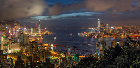 Panorama Hong Kong Cityscape skyscraper at twilight time, Hong Kong central and Kowloon island, Victoria peak and harbour, adventure and trekking at red incense burner summit view point for traveler