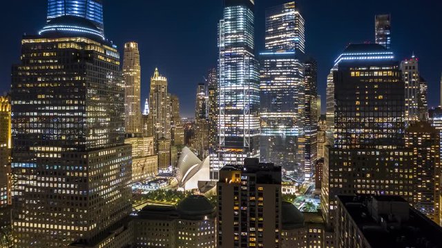 Aerial drone hyperlapse of New York skyline at night with pull back motion away from the Lower Manhattan skyscrapers