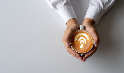 closeup man hands holding cups of coffee on white table background