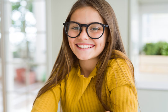 Beautiful young girl kid wearing glasses with a happy and cool smile on face. Lucky person.