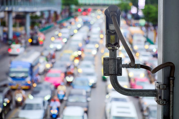 Rear view of CCTV cameras that installed on footbridge to monitor on blurred traffic and safety on the road of the capital
